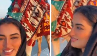 ‏فتاة تتجول برفقة جمل في اليوم الوطني للمملكة..فيديو